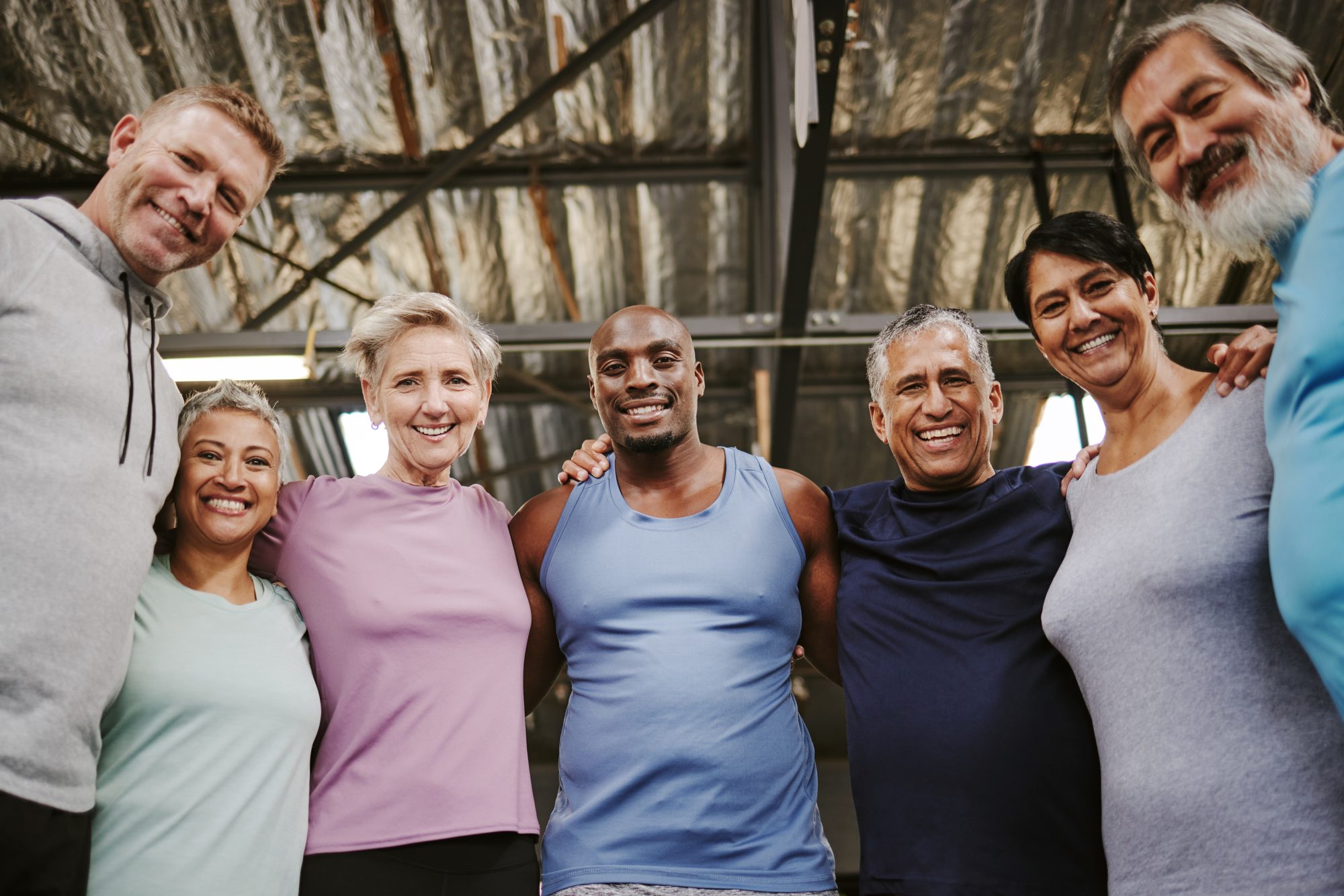 A diverse group of adults smiling together after a wellness class